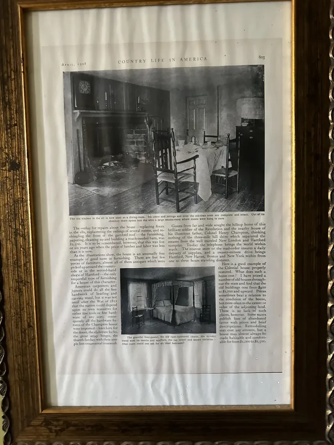 A framed 1908 Country Life in America magazine article about the house's dining room and bedrooms