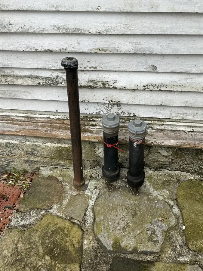 Old standpipes at the foundation, remnants of earlier building systems
