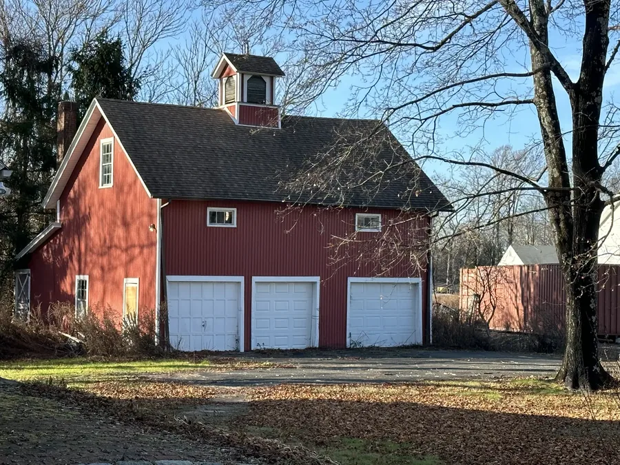 The barn, with its cupola and three garage bays, on a clear winter day