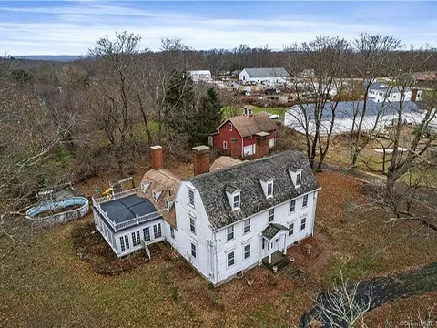 Winter aerial view of the full property, showing the house, pool, and barn